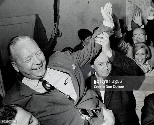 Ted high on the shoulders of his supporters; Economics Minister Stanley Randall gives a victory wave last night after holding his of Don Mills;...