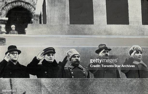 Saluting Russian Army warriors as they parade before the Lenin mausoleum on Red Square in Moscow; Nov. 7; are; left to right: A. F. Gorkin; M. E....