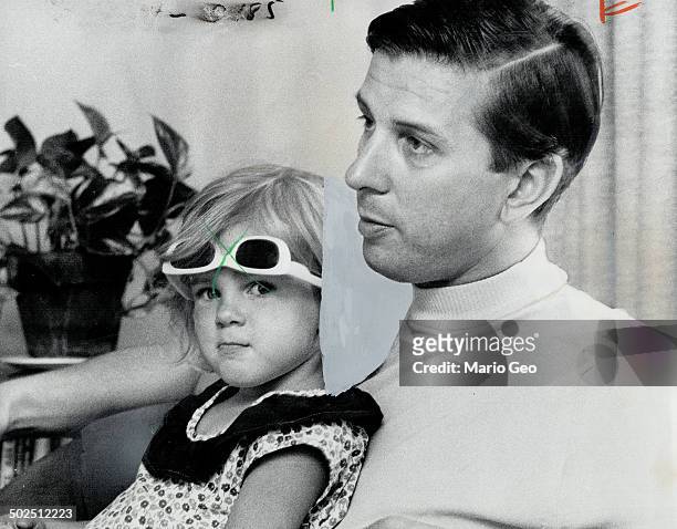 Lloyd Robertson is that nice-looking man who read the CBC-TV national news during Stanley Burke's vacation. That's his 3-year-old daughter; Lynda....
