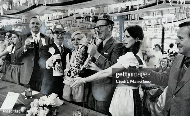 To Shout of Prosit; a German toast to good health; Mayor William Dennison raises five-quart stein of beer at opening last night of Metro's three-day...