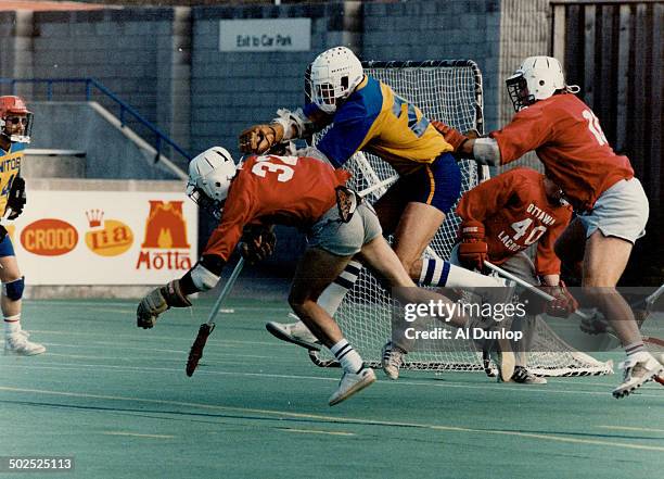 Tight checking: Manitoba's Dave Gillis is caught in crunch between Ottawa's Peter Mutch and Dave Moran at the Canadian Field Lacrosse Championships...