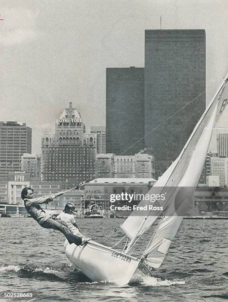 Perfect day for sailing; With a stiff breeze ruffling the sparkling waters of Toronto Harbor yesterday; Billy Ellis does a balancing act on Royal...