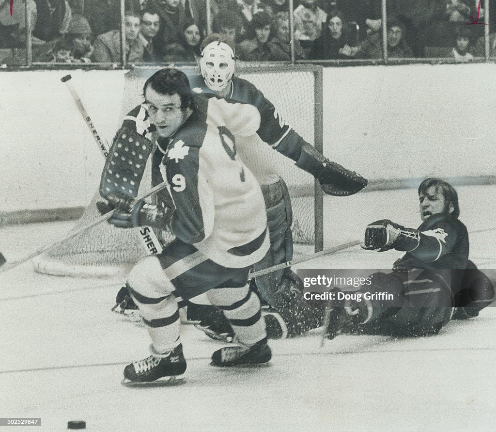 Where did it go? Maple Leafs' Norm Ullman (9) can't seem to see puck as he wheels away from Vancouve