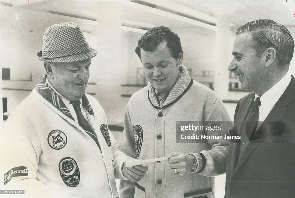Helping hand from curlers. Paul Savage (centre); skip of Ontario rink in Canadian curling championsh