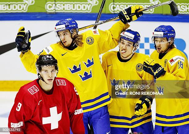 Sweden's William Lagesson, Dmytro Timashov and Rasmus Asplund celebrate their team's 2-7 goal during the 2016 IIHF World Junior Ice Hockey...