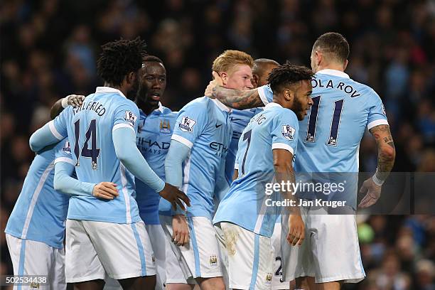 Kevin De Bruyne of Manchester City is congratulated by teammates after scoring his team's fourth goal during the Barclays Premier League match...