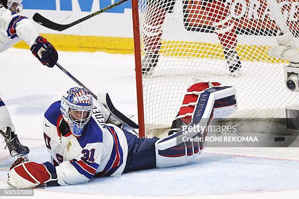 Goalkeeper Alex Nedeljkovic eyes the puck he failed to save during the 2016 IIHF World Junior Ice Hockey Championship match between USA and Canada in...