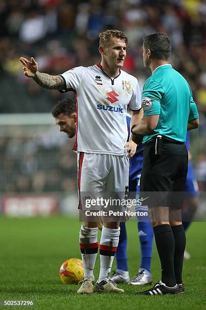 Referee Iain Williamson makes a point to Kyle McFadzean of Milton Keynes Dons during the Sky Bet Championship match between Milton Keynes Dons and...