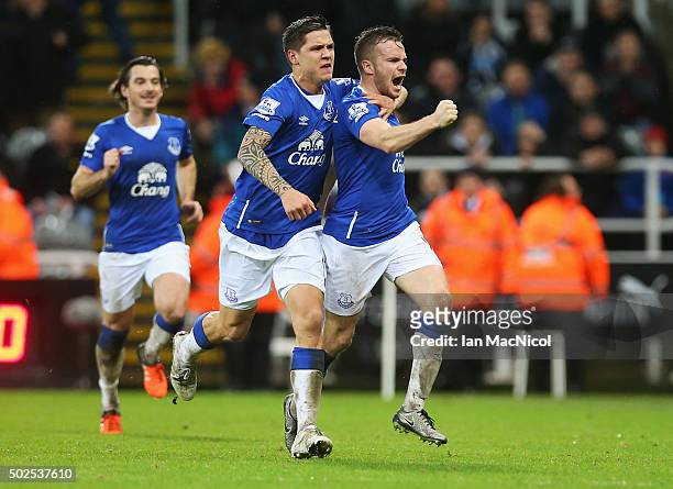 Tom Cleverley of Everton celebrates with team mate Muhamed Besic as he scores their first goal during the Barclays Premier League match between...