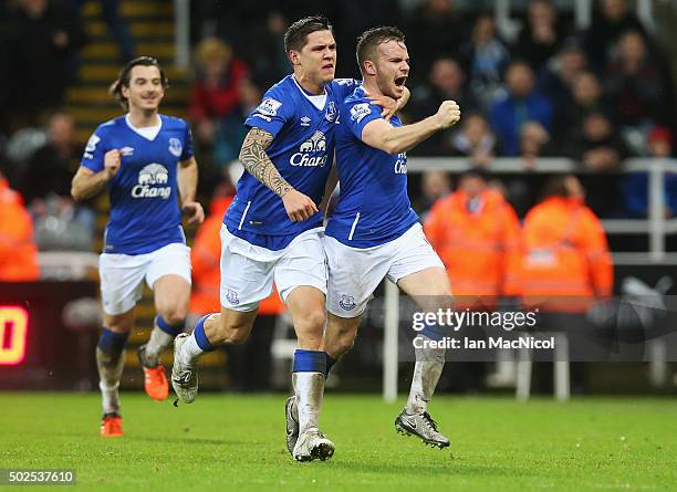 Tom Cleverley of Everton celebrates with team mate Muhamed Besic as he scores their first goal during the Barclays Premier League match between...