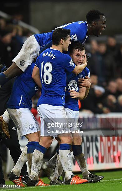 Tom Cleverley of Everton is mobbed by team mates in celebration as he scores their first goal the Barclays Premier League match between Newcastle...