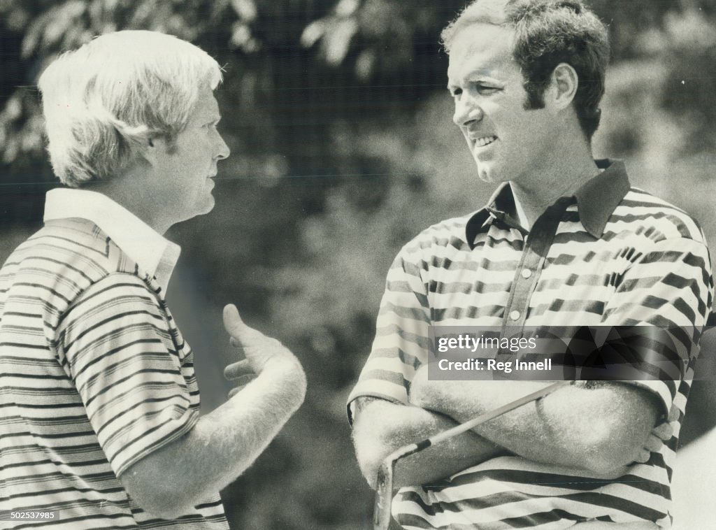 Out: Jack Ncklaus (left) chats with Tom Weiskopf; the defending champion; during a break in play at 