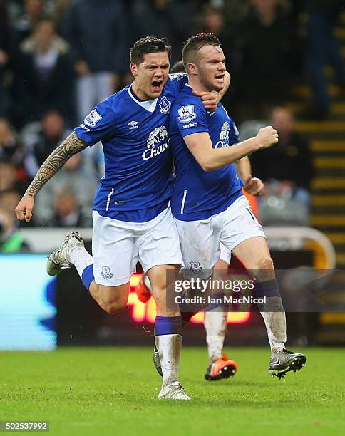 Tom Cleverley of Everton celebrates with team mate Muhamed Besic as he scores their first goal during the Barclays Premier League match between...