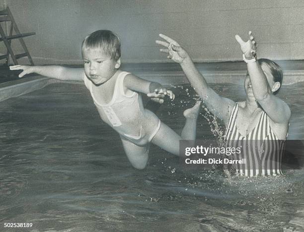 Wendy Carter; 3; is obviously unafraid of the water as her swimming instrutor; Barbara Ferdinandi; playfully tosses her in the pool. Wendy is one of...