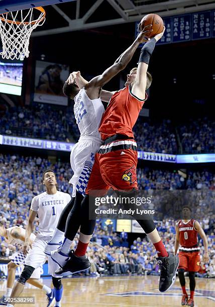Alex Poythress of the Kentucky Wildcats blocks the shot of Matz Stockman of the Louisville Cardinals during the game at Rupp Arena on December 26,...