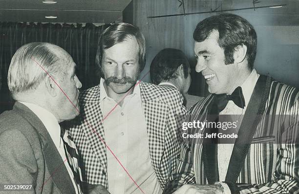 Ed Westfall ; winner of Charlie Conacher Memorial Trophy; enjoys laugh as he chats with Maple Leafs' vice-president King Clancy and Eddie Shack...