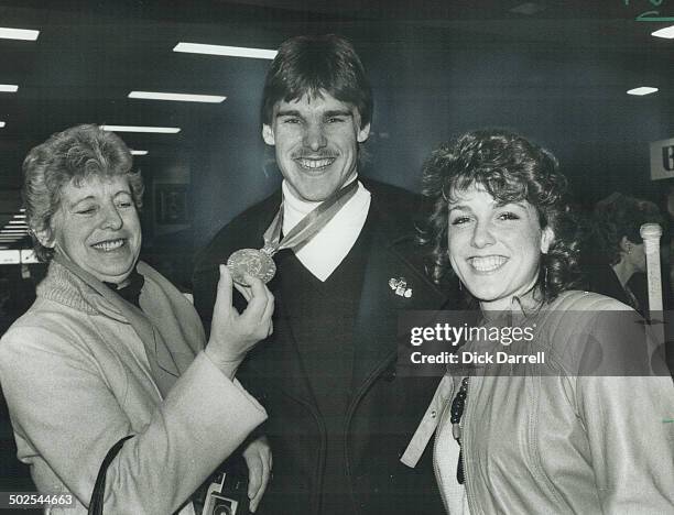 Hockey hero welcomed by proud mom; It's all smiles as Canadian defenceman Jeff Beukeboom shows off his junior hockey world championship medal to mom...