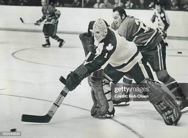 Who have we here?; Frank Mahovlich of Montreal Canadiens must have been surprised when he found a puck-carrying Jacques Plante stick-handling past...