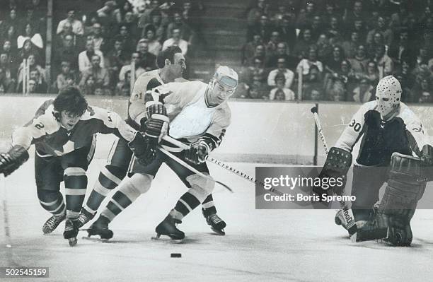 Everything under control: While Toronto defenceman Rick Ley stretches to reach sliding puck; his fellow rearguard Bob Baun takes care that Dave Balon...