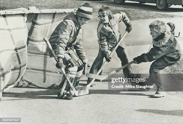 Even street hockey captures the enthusiasm of Orangeville superstar; 8-year-old Bobby Cooke as he plays with chums Ron Costescu ; 12; and David...