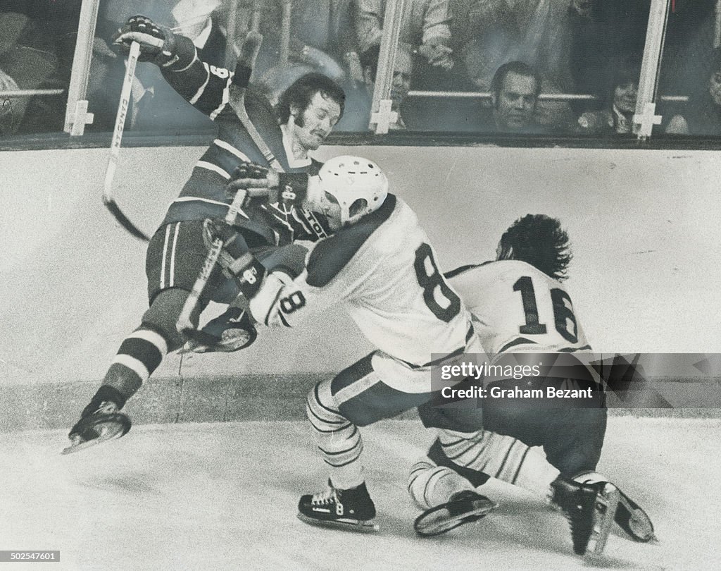 Heading for fall; Montreal Canadiens' defenceman Larry Robinson grimaces as he collides with Jim Lor