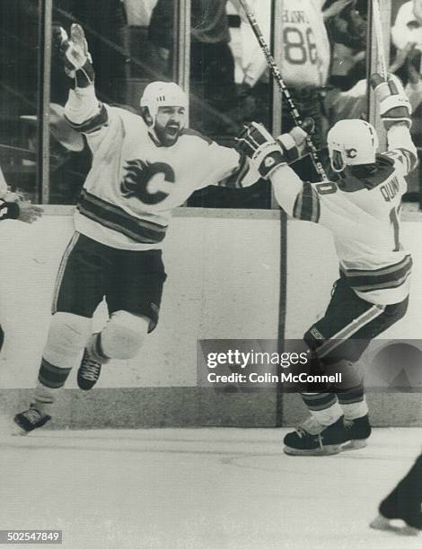 Happy chaps: John Tonelli; left; lets out a cheer and skates to hug teammate Dan Quinn after scoring the first goal of Stanley Cup game against the...