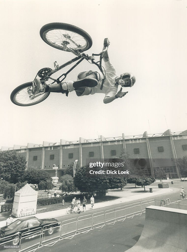 New slant on the ex: Daredevil cyclist Creig Litherland; 19; flies above Exhibition Place yesterday 