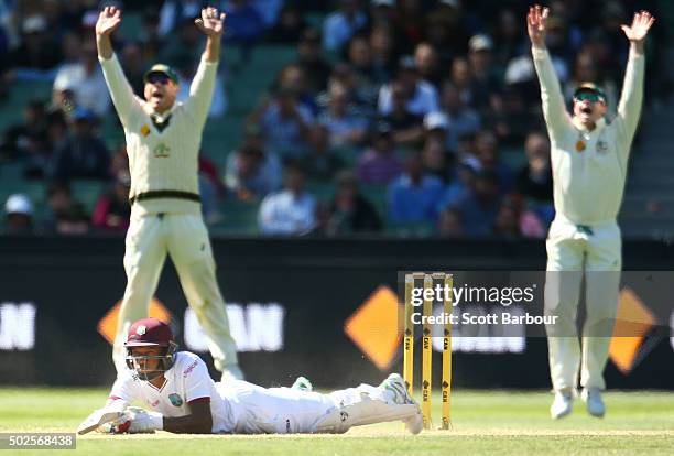 David Warner and Steven Smith of Australia appeal as Jermaine Blackwood of the West Indies falls over after almost being bowled by a yorker bowled by...