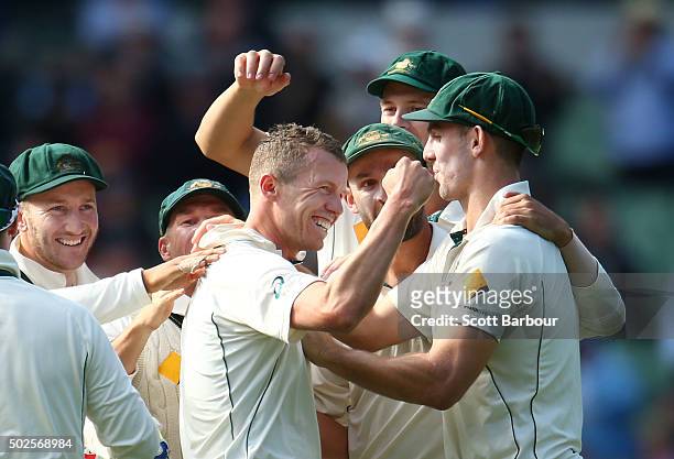 Peter Siddle of Australia is congratulated by his teammates after dismissing Jason Holder of the West Indies during day two of the Second Test match...