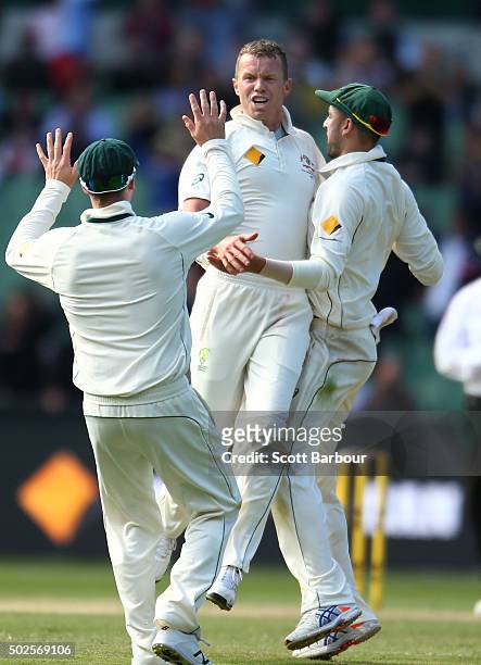 Peter Siddle of Australia is congratulated by Steven Smith and Nathan Lyon after dismissing Jason Holder of the West Indies during day two of the...