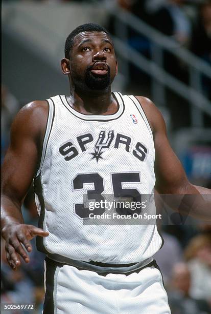 Antoine Carr of the San Antonio Spurs looks on against the Phoenix Suns during an NBA basketball game circa 1992 at the HemisFair Arena in San...