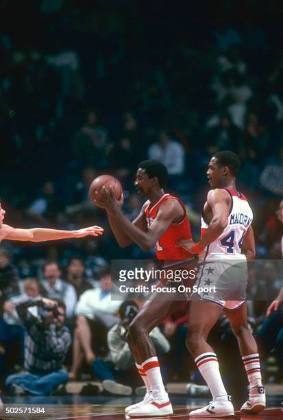 Caldwell Jones of the Philadelphia 76ers grab a rebound over Elvin Hayes of the Washington Bullets during an NBA basketball game circa 1982 at the...