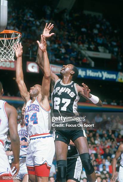 Caldwell Jones of the San Antonio Spurs battles for a rebound with Charles Barkley of the Philadelphia 76ers during an NBA basketball game circa 1977...