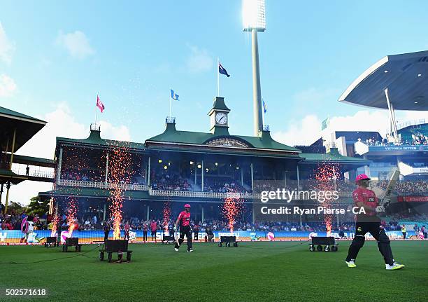 Michael Lumb and Brad Haddin of the Sixers walk out to bat during the Big Bash League match between the Sydney Sixers and the Melbourne Stars at...