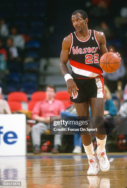 Clyde Drexler of the Portland Trail Blazers dribbles the ball against the Washington Bullets during an NBA basketball game circa 1992 at the Capital...