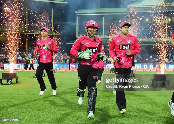 Jackson Bird, Brad Haddin and Michael Lumb of the Sixers run out to field during the Big Bash League match between the Sydney Sixers and the...