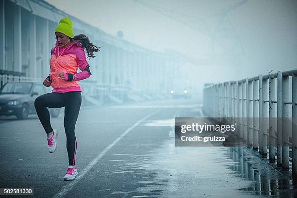 young athlete woman exercises bouncing up and down outdoors - reenactment stock pictures, royalty-free photos & images