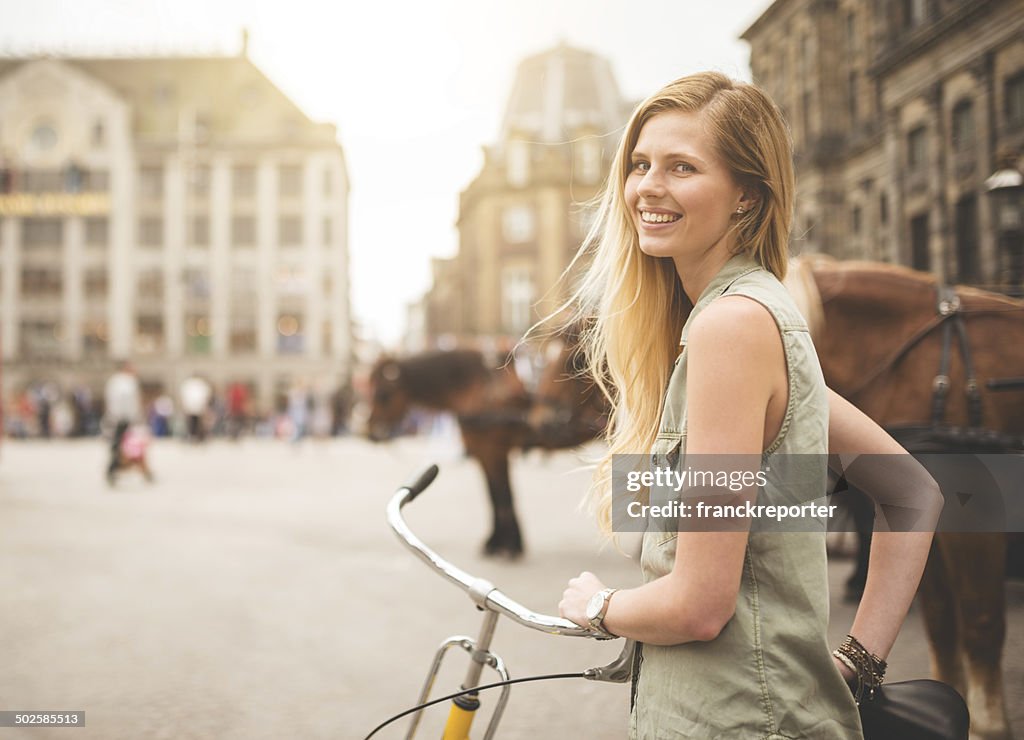 Dutch woman with bicycle in amsterdam walking