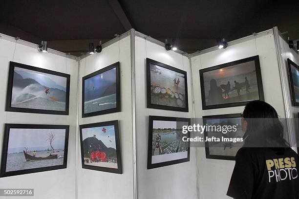 People pays a visit at a photo exhibition on Tsunami 2004, by a photojournalist during the 11th anniversary of the 2004 Indian Ocean Tsunami, also...