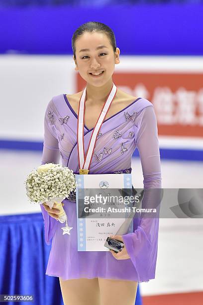 Mao Asada of Japan poses with her bronze medal during the day three of the 2015 Japan Figure Skating Championships at the Makomanai Ice Arena on...