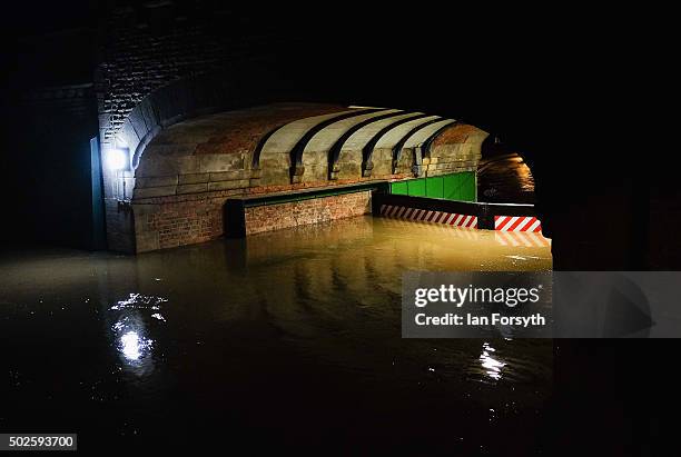 Water levels rise high against a flood barrier as water floods from the river Ouse on December 27, 2015 in York, England. Heavy rain over the...