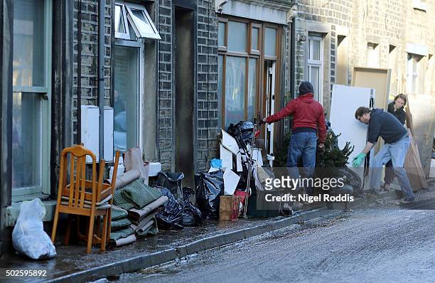 Residents empty their houses after flooding on December 27, 2015 in Mytholmroyd, England. Heavy rain has caused more flooding in northern England,...