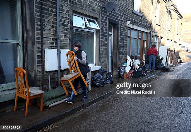 Residents empty their houses after flooding on December 27, 2015 in Mytholmroyd, England. Heavy rain has caused more flooding in northern England,...