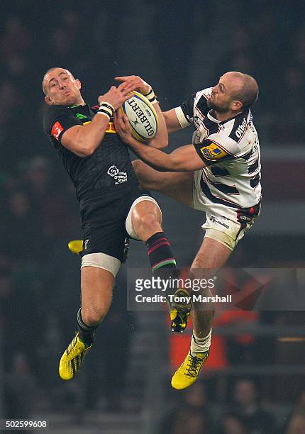 Mike Brown of Harlequins jumps for a high ball with Charlie Sharples of Gloucester during the Aviva Premiership "Big Game 8" match between Harlequins...