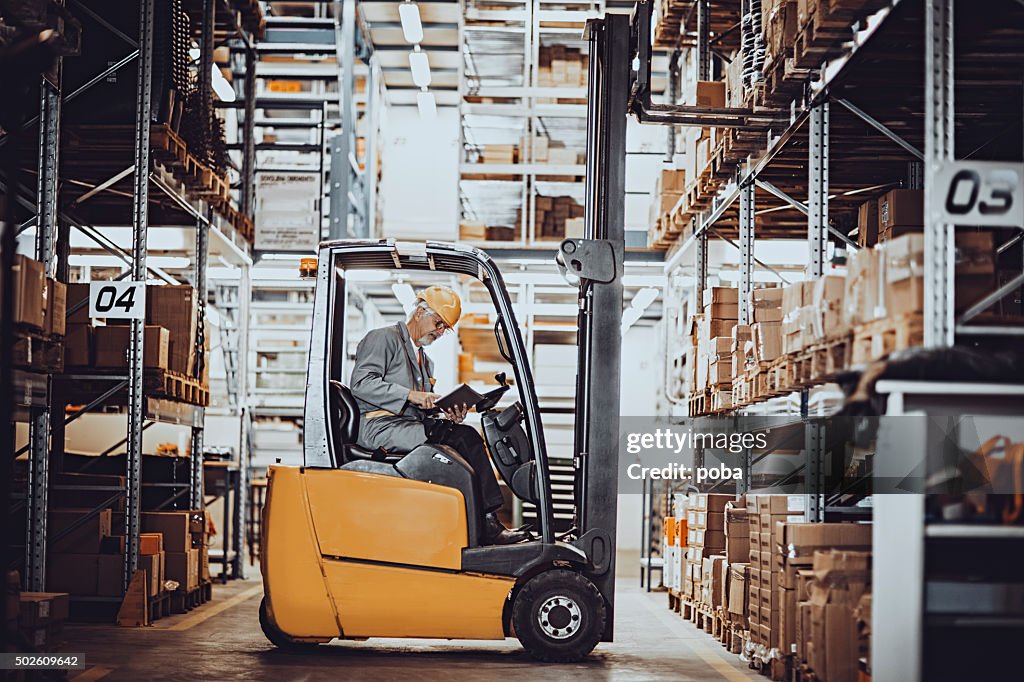 Forklift operator at warehouse