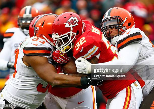 Running back Spencer Ware of the Kansas City Chiefs carries the ball as inside linebacker Craig Robertson of the Cleveland Browns defends during the...