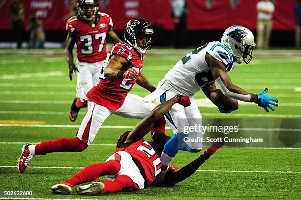 Robert Alford and Phillip Adams of the Atlanta Falcons break up a pass intended for Jerricho Cotchery of the Carolina Panthers during the first half...