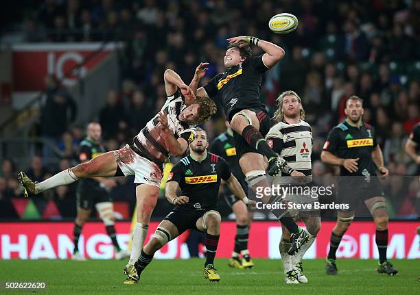 Charlie Matthews of Harlequins jumps for a high ball with Billy Twelvetrees of Gloucester during the Aviva Premiership "Big Game 8" match between...