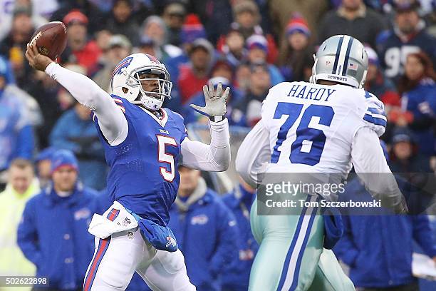 Tyrod Taylor of the Buffalo Bills throws downfield as Greg Hardy of the Dallas Cowboys pursues the play during the first half at Ralph Wilson Stadium...