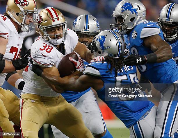Jarryd Hayne of the San Francisco 49ers carries the ball in first quarter while he tries to brake the tackle by Josh Bynes of the Detroit Lions at...